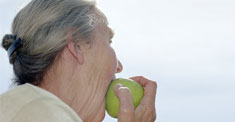 older woman eating fruit photo
